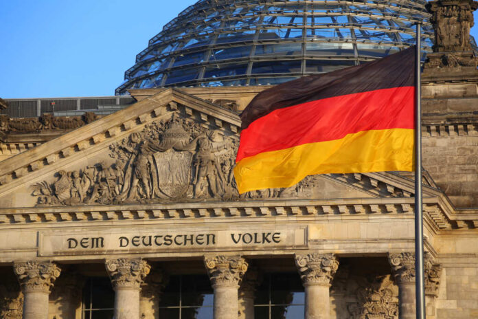 The,German,Flag,In,Front,Of,The,Reichstag,Building,In