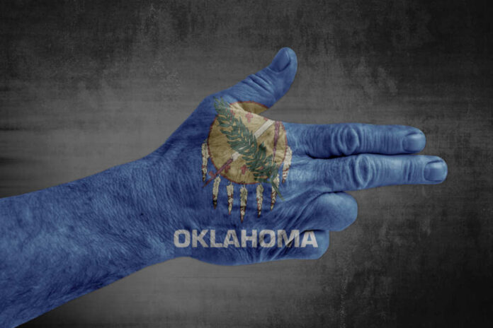Oklahoma,State,Flag,Painted,On,Male,Hand,Like,A,Gun