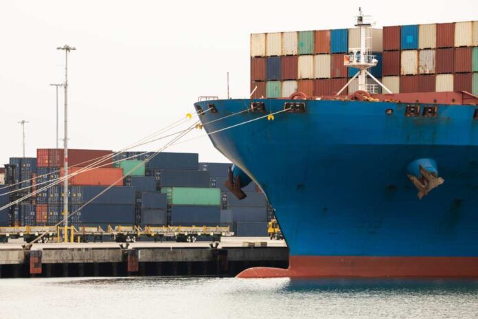A,Cargo,Vessel,Full,Of,Containers,Sits,Docked,At,Port.