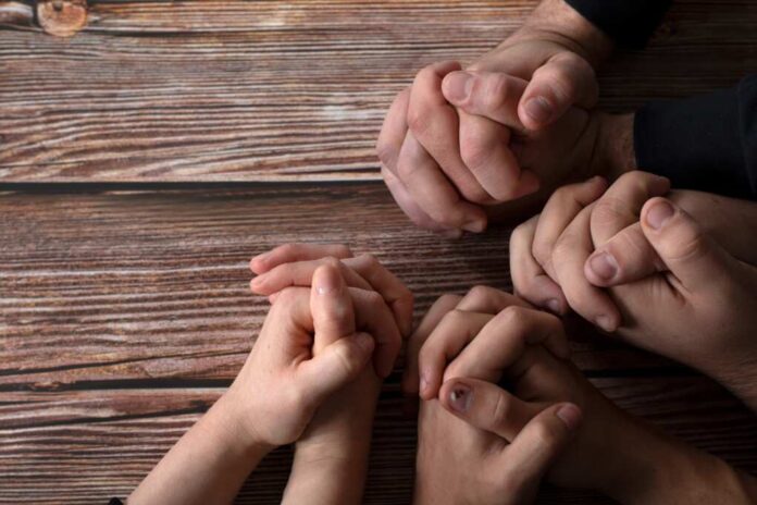Praying,Hands,On,A,Wooden,Background,With,Copy,Space.,Top