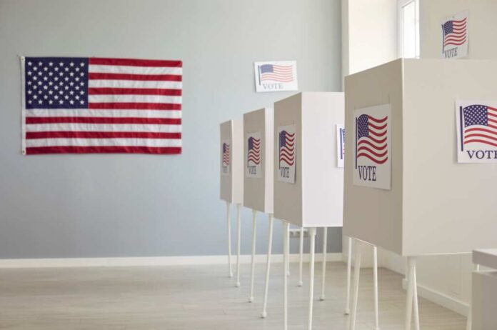White,Empty,Voting,Booths,At,Polling,Station,With,American,Flag.