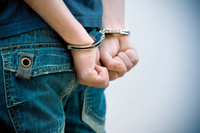 Young,Man,In,Handcuffs