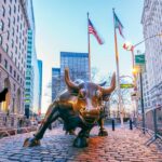 Major Fund FREEZES Withdrawals—What’s Really Happening? Bronze charging bull sculpture in a city street