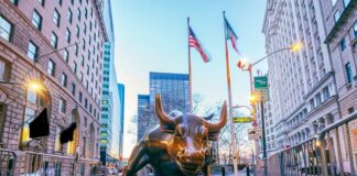 Bronze charging bull sculpture in a city street