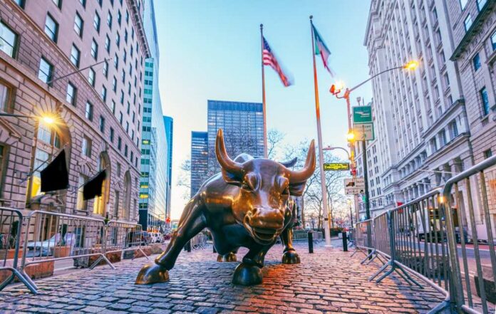 Bronze charging bull sculpture in a city street