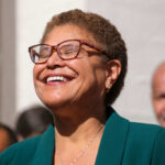 Desperate Move: L.A. Reopens Iconic Film Sites A smiling woman in a green blazer at an outdoor event