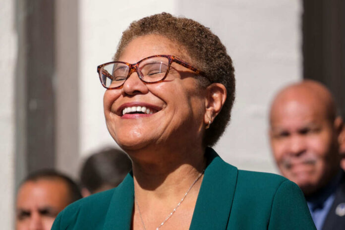shutterstock2227690021jpg A smiling woman in a green blazer at an outdoor event