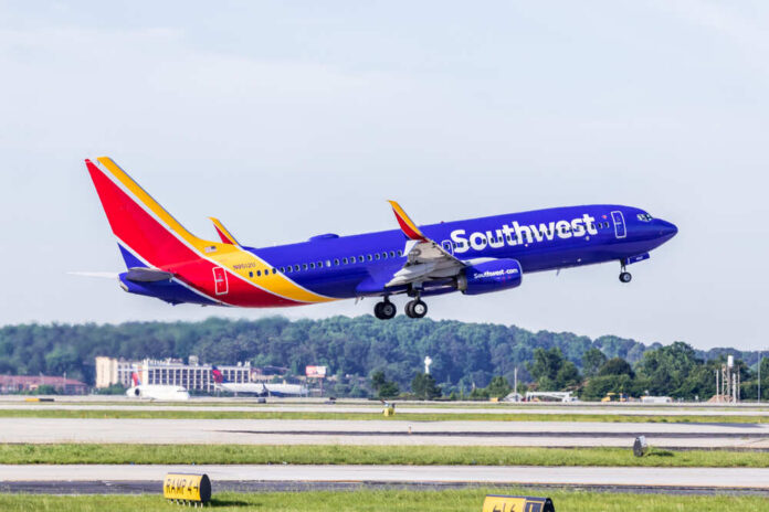 A Southwest Airlines airplane taking off from an airport runway