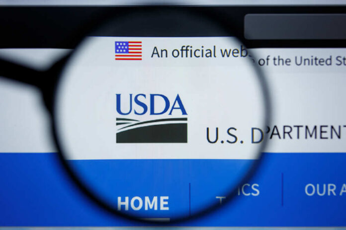 Close-up view of the USDA website logo through a magnifying glass