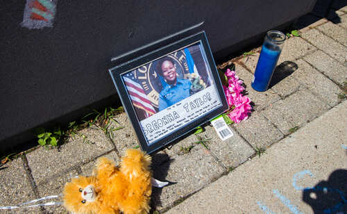 Memorial tribute with a photo, flowers, and a candle