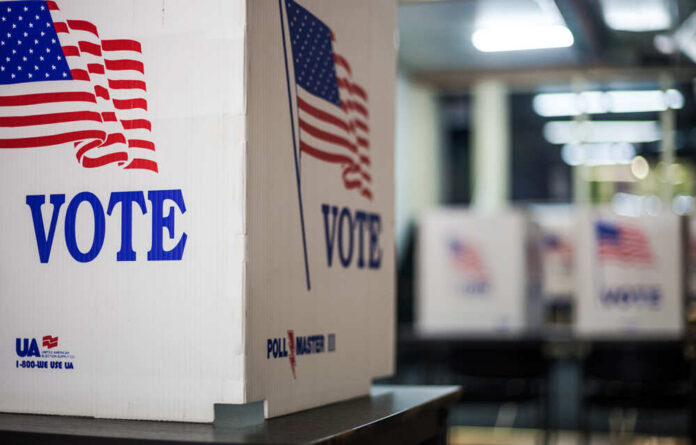 Voting booths with American flags in a polling station