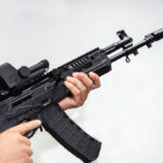Terrorism Fears in Austin Bar Attack Person holding an AK-47 rifle with a scope
