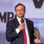 Colombian Leader’s Alleged Drug Links: US Probes A man in a suit speaking into a microphone at an event