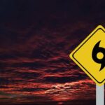 Tornado Season Explodes Early Across America A yellow hurricane warning sign against a dramatic sunset sky