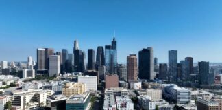 Aerial view of a city skyline with tall buildings under a clear blue sky