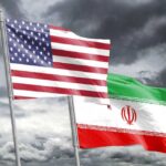 Trump’s War Timeline Questioned: Endless Conflict Fears Flags of the United States and Iran waving against a cloudy sky