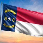Obama-Appointed Judge Upholds Voter ID—Unbelievable! North Carolina state flag waving against a sunset sky