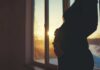 HORRIFYING Forced Abortion Push for Minors Silhouette of a pregnant woman standing by a window at sunset
