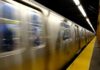 NYC Subway Horror: Hero Veteran’s Tragic End A subway train in motion at a station with blurred reflections