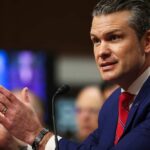 Pentagon’s Radical Chaplain Shift — Will It Backfire? A man in a blue suit speaking passionately at a podium during a hearing