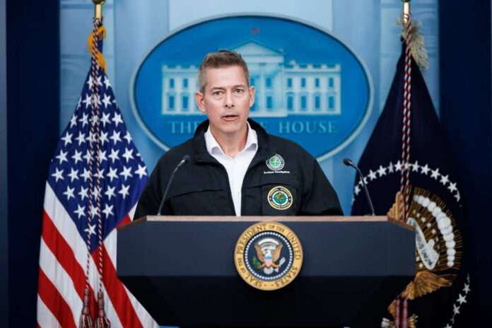 shutterstock_2586171387.jpg Government official speaking at a podium during a press conference at the White House