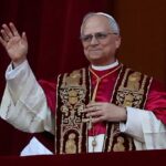 Pope’s Controversial Pick: Church Reforms at Stake? A religious leader in papal attire waving from a balcony