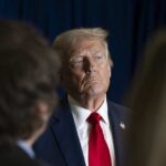 Trump’s Fiery Warning: Iran’s New Leader in Jeopardy A serious-looking political figure in a suit and red tie during a media interaction