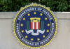 FBI seal featuring the Department of Justice emblem on a wall