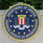 FBI seal featuring the Department of Justice emblem on a wall