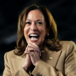 White House Mocks: Harris’s Preemptive Strike Fails A woman in formal attire smiling broadly while speaking at a podium