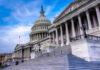 The U.S. Capitol building with its iconic dome and steps under a blue sky