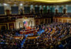 A large gathering of officials in a congressional chamber during a legislative session
