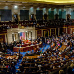 A large gathering of officials in a congressional chamber during a legislative session
