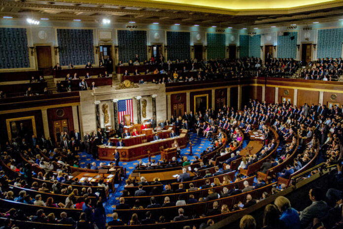 A large gathering of officials in a congressional chamber during a legislative session