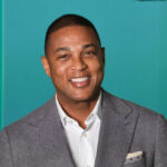 Outsider Politics: Lemon’s Surprising Presidential Tease Smiling man in a gray suit with a colorful background
