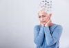 Elderly woman with a unique hairstyle made of puzzle pieces, looking thoughtful