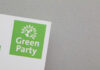 Logo of the Green Party featuring a globe and sun design