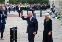 King Charles III and Camilla, Duchess of Cornwall, greeting a crowd during a public event