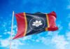 Mississippi state flag waving against a blue sky