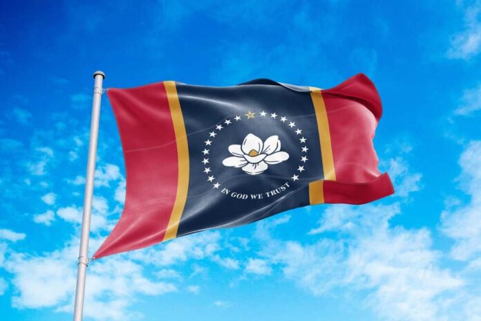 Mississippi state flag waving against a blue sky
