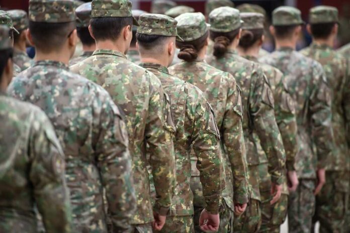 Line of soldiers in camouflage uniforms standing in formation