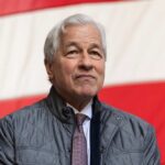 A business leader standing in front of an American flag