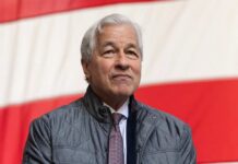 A business leader standing in front of an American flag