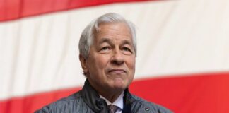 A business leader standing in front of an American flag