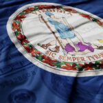 Virginia Governor’s Shocking Popularity PLUMMET Virginia state flag featuring a central emblem on a blue background
