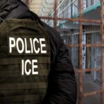 Police officer in tactical gear standing in a detention center