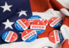 Voting buttons on an American flag background