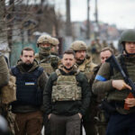 Zelensky’s Desperate Missile Plea Hits Trump’s Wall A group of military personnel in tactical gear walking through an urban area