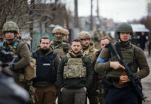 Zelensky’s Desperate Missile Plea Hits Trump’s Wall A group of military personnel in tactical gear walking through an urban area
