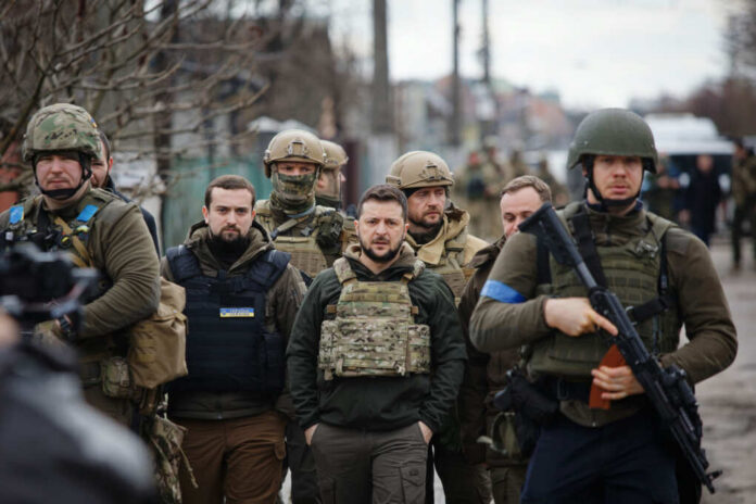 A group of military personnel in tactical gear walking through an urban area